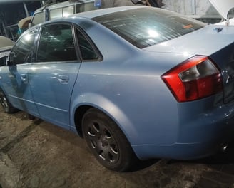 a Audi blue car parked in a garage