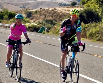 A man and a woman cycling in the outdoors