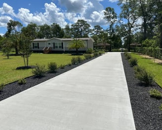 a driveway with a driveway and a house