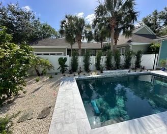 a pool with a pool and a house in the background