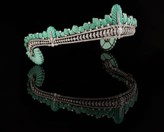 Angled view of Nancy Astor’s Cartier turquoise and diamond tiara with reflection on black surface.