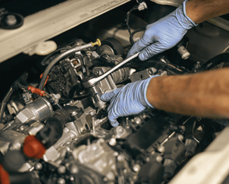 Mechanic tightening a car part during maintenance to ensure optimal vehicle performance