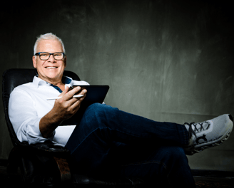Martin sitting in a chair with a tablet