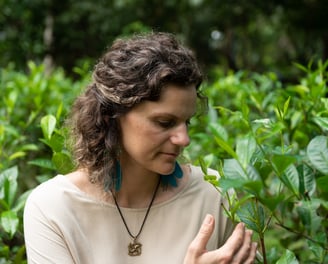 a woman in a white shirt and a necklace with a necklace