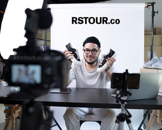 a man sitting at a table with a camera and a camera