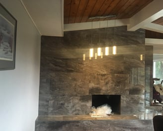 large format tile over brick fireplace