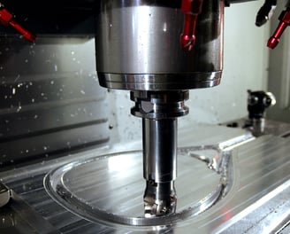 a CNC machine is making a hole in the center of a machine