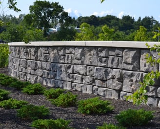 a stone wall with a stone wall and a bench