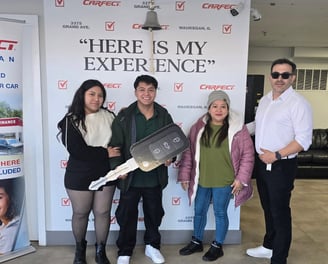 a group of people standing in front of a sign