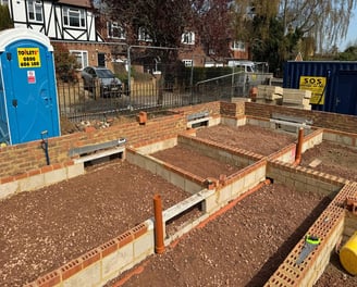 Groundwork contractor overseeing footing work
