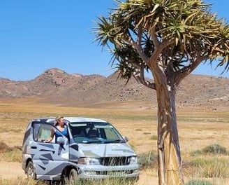 Lady in desert near beautiful tree 