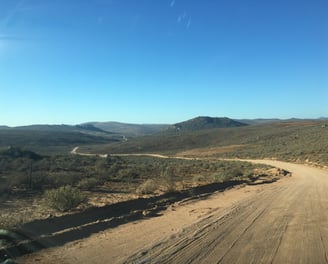 winding dirt road overlooking hills