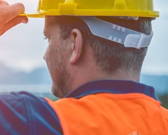 a man in a hard hat and safety vest