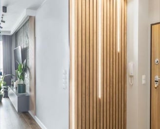 a hallway with a wooden paneled wall and a wooden door