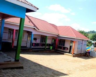 a building with a colorful painted wall and a colorful umbrella