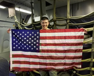 Bert, holding the American flag while on a KC-10 Tanker during his last deployment
