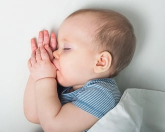 a baby sleeps soundly in its cradle