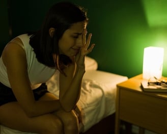 a woman struggles to sleep after discovering bed bugs in her bed