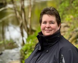 Karen Webster, freelance Proofreader and copy editor, looking at the camera on hike in Wales