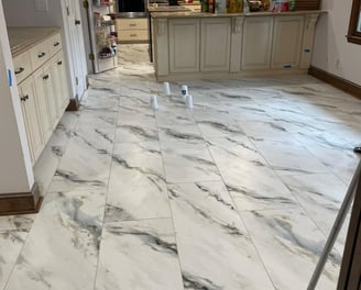 a kitchen floor with a mop and a mop