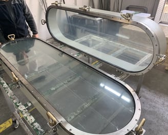 Oblong stainless ship windows in workshop