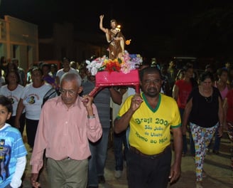 Procissão noturna com imagem de São João durante festa tradicional em comunidade quilombola