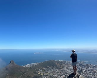 The top of Table Mountain with a view of Lions Head, Robben Island and Cape Town