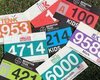 a photo of a pile of multi-colore race bibs