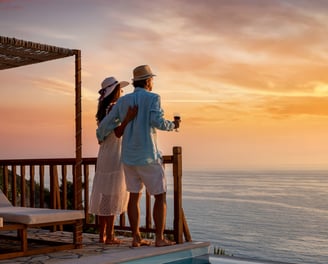 a couple of people standing on a deck overlooking the ocean