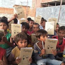 a group of children holding up books and holding up their books