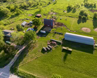 a farm with a barn and a barn in the background