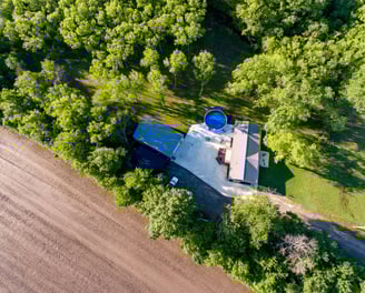 a house with a blue water tank and a blue bucket