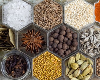 a tray of whole spices and some powdered. 