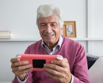 a man in a pink sweater and sweater with a pink phone