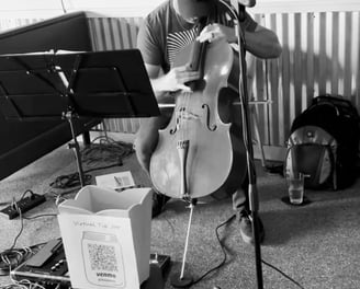 Treavor Eaton Music performing his cello at a restaruant