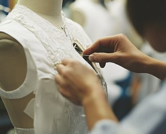 a woman is working on a dress - like dress