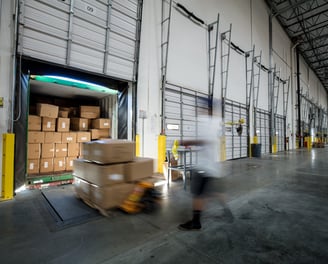 Loading a 26ft box truck at a loading dock in a business with a pallet jack.