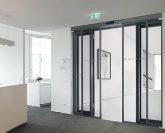 a office with a large glass door and a counter