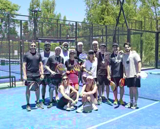 grupo de personas posando en una cancha de padel