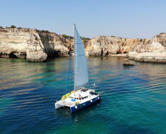 a sailboat in the water with a sailboat in the background