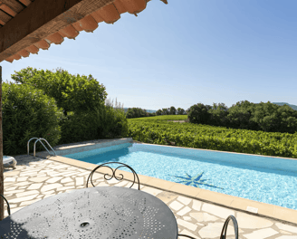 a pool with a table and chairs