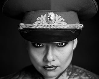 a woman in a military uniform with a hat on