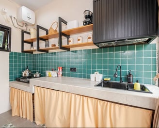 Fully equipped kitchen with modern appliances, countertops, and storage.