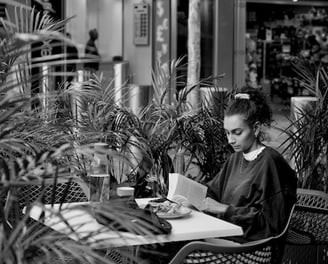 The lens of Peter Pickering does not interrupt the girls reading of her book