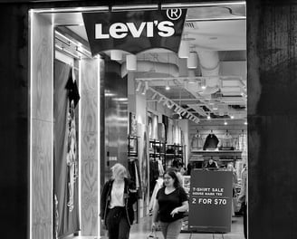 Two female shoppers leaving a Levi's store captured by photographer Peter Pickering