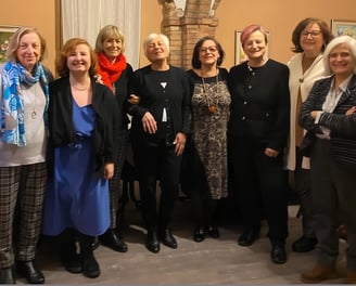 a group of women standing in a room