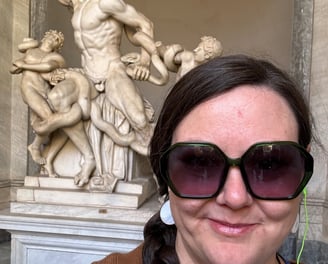 Cassie standing in front of Laocoon, a sculpture in the Vatican