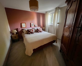 a bedroom with a bed and a wooden cabinet
