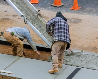 two men working on a concrete slab