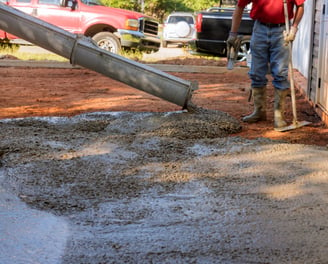 a man is pouring cement into a concrete wall